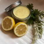 all natural essential oil salve on counter with lemons