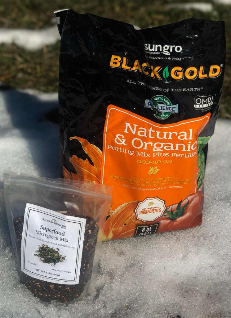 Black Gold potting soil and superfood Microgreen mix resting in the snow