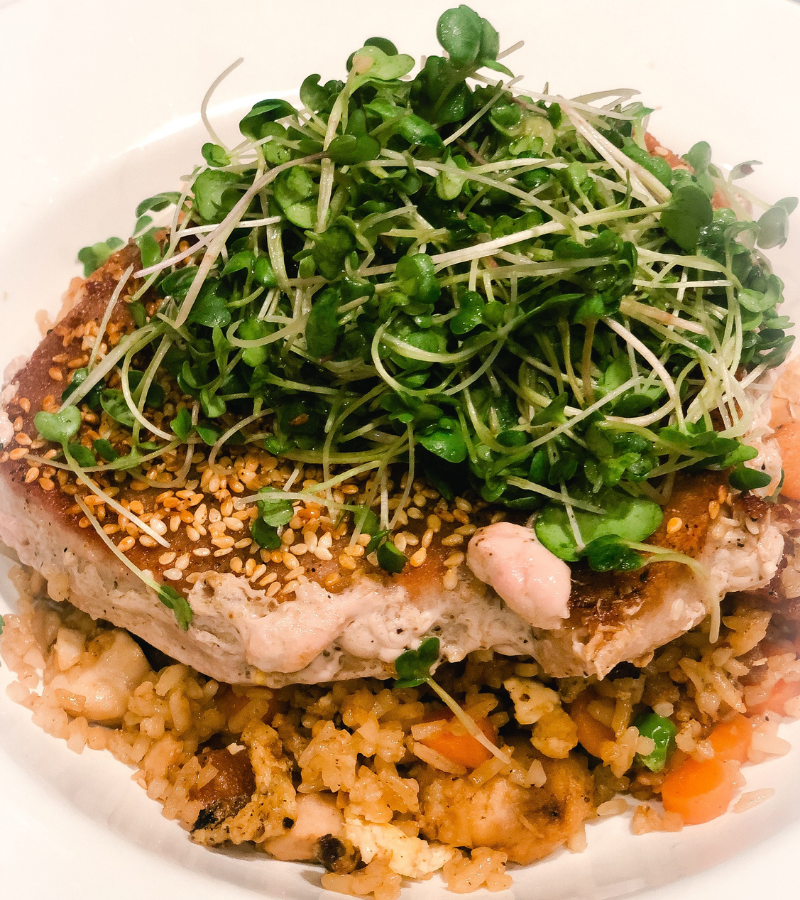 Home grown indoors greens tossed in sesame dressing and piled high on top of seared tuna. 