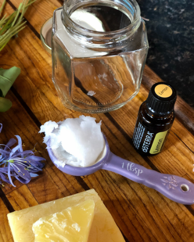 Spoon butter isn't just for wooden spoons. It is a deep conditioner for ALL your wooden kitchen utensils. This easy essential oil infused recipe keeps your tools nourished so they will last much longer. NO MINERAL OIL IN THIS RECIPE. This spoon butter is all natural:
- Coconut Oil
- Beeswax
- Lemon Essential Oil
Wooden kitchen tools are healthy, beautiful investment. Keep them well cared for with this easy melt and pour wood butter recipe.. 