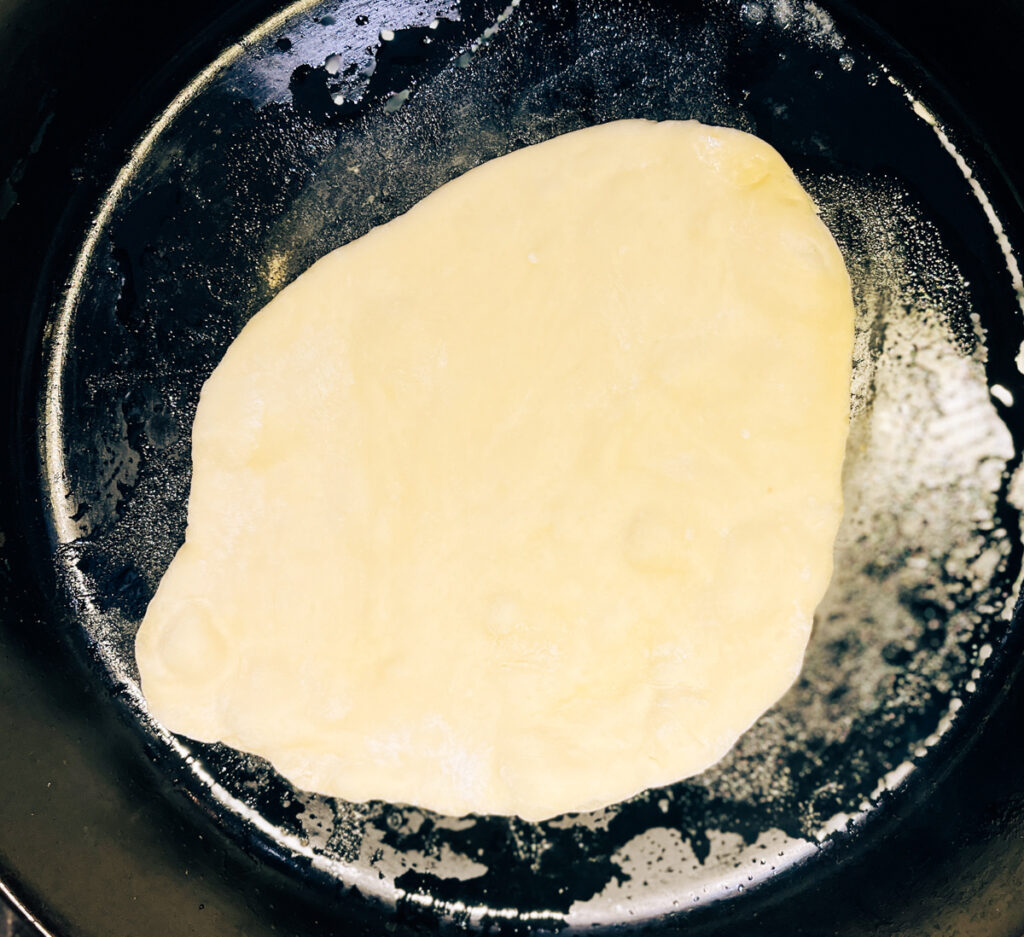 Easy Cast Iron Skillet Yeast Flatbread cooking on the first side