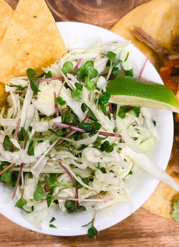 This Mexican Coleslaw is crisp and refreshing. The slightly sweet, citrus, vinegar & spice is an excellent contrast and compliment to rich Tex-Mex dishes including tacos, enchiladas, nachos and more. Radish Microgreens are the star adding vibrant color and a delightful spicy crunch!