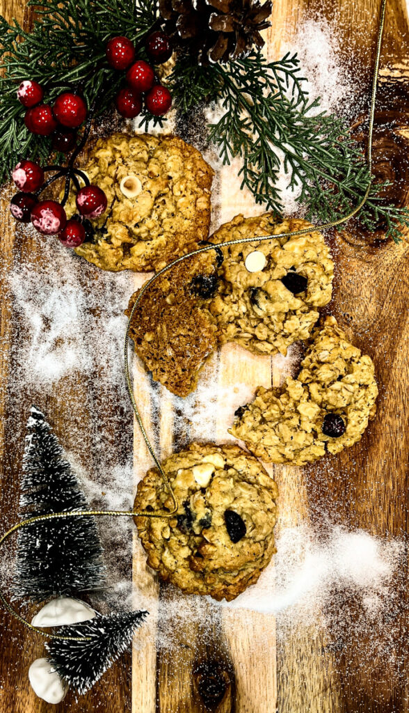 Chewy White Chocolate Cranberry Oatmeal Cookie on board sprinkled with sugar snow