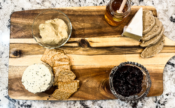 3. Add bread/crackers next to cheeses.